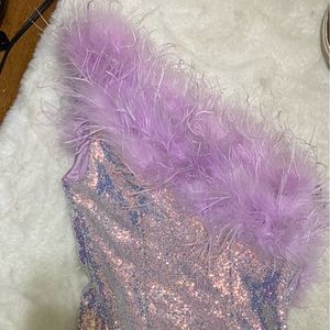 Small, sequined, body con dress. Feather detail around the top